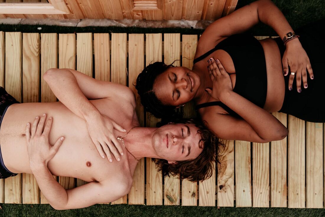 Three RITUAL members resting on the warm deck between rounds, eyes closed